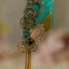 Ornate gold metal handle showing detailed scrollwork