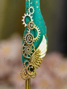 Upper half of the teal feather showing gold dust paint splatters