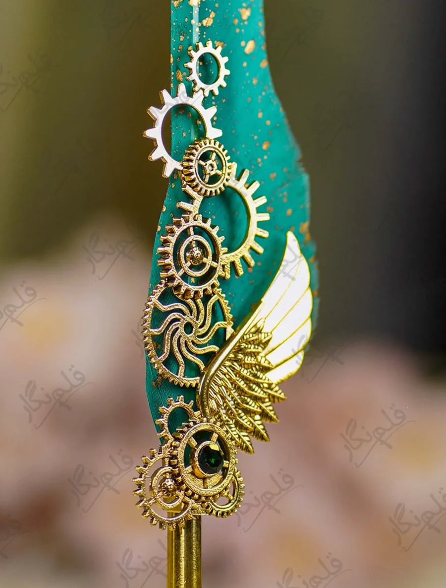 Upper half of the teal feather showing gold dust paint splatters