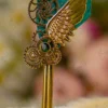 Upper tip of the teal quill feather close up showing gold splatters