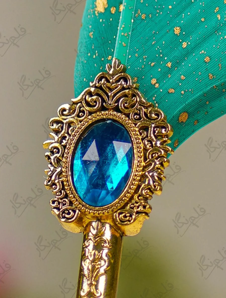 Detailed shot of the gold mirror nameplate on teal feather