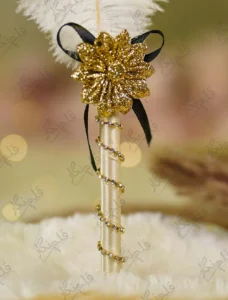 Detailed shot of the black ribbon bow and textured gold flower centerpiece