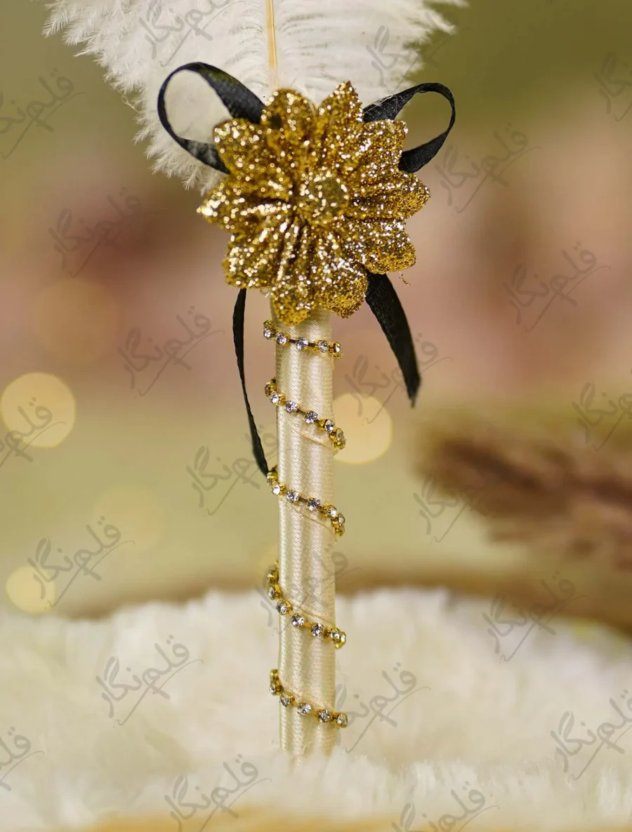 Detailed shot of the black ribbon bow and textured gold flower centerpiece