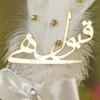 Close up of the golden mirror acrylic Qabool Hai script on the white feather