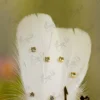 Detailed shot of the white satin bow and central crystal rhinestone