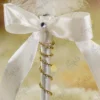 High angle shot showing the white satin ribbon and gold rhinestone chain wrap