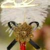 Close up of the black bow centerpiece and red ribbon wrap on handle