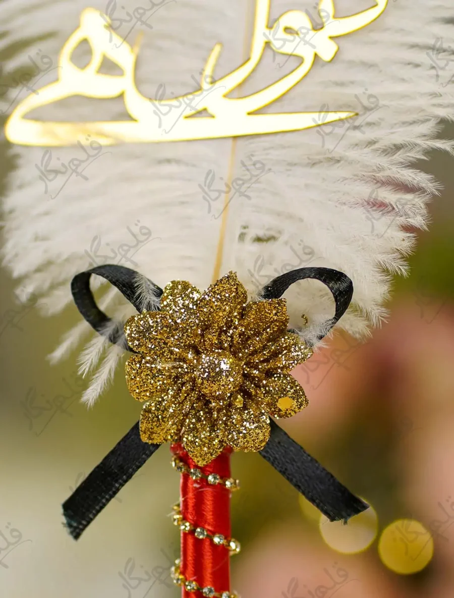 Close up of the black bow centerpiece and red ribbon wrap on handle
