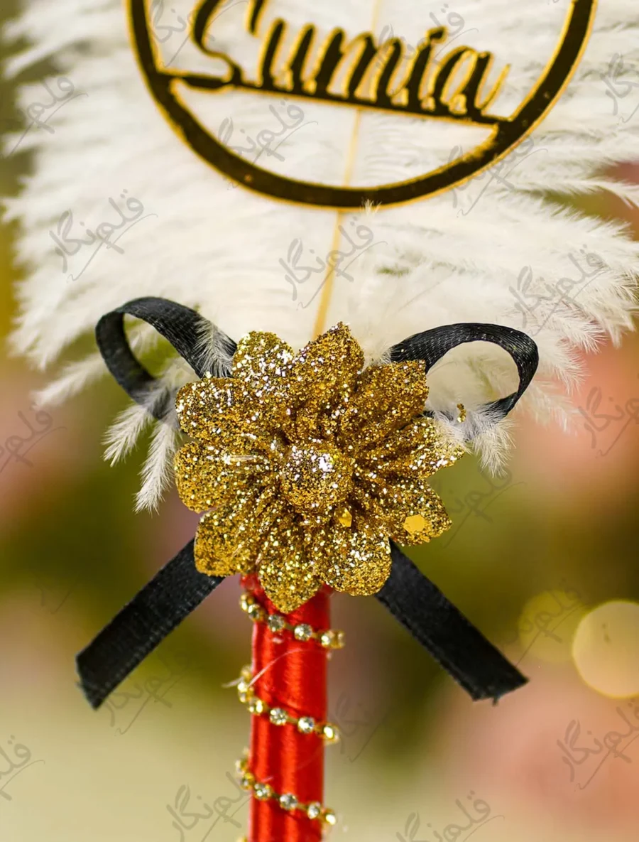 Detailed close up of the red satin handle with gold rhinestone spiral