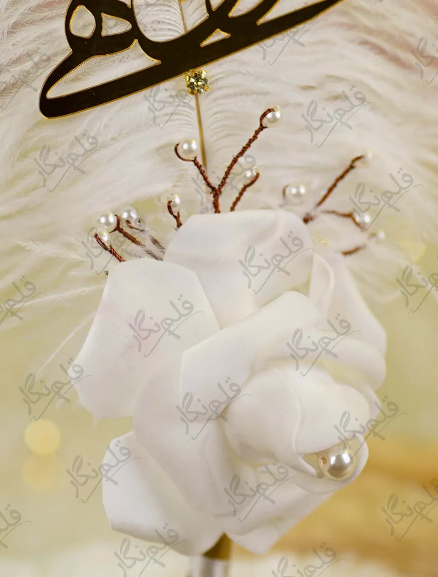 Detailed shot of the hand rolled white satin rose and pearl sprigs